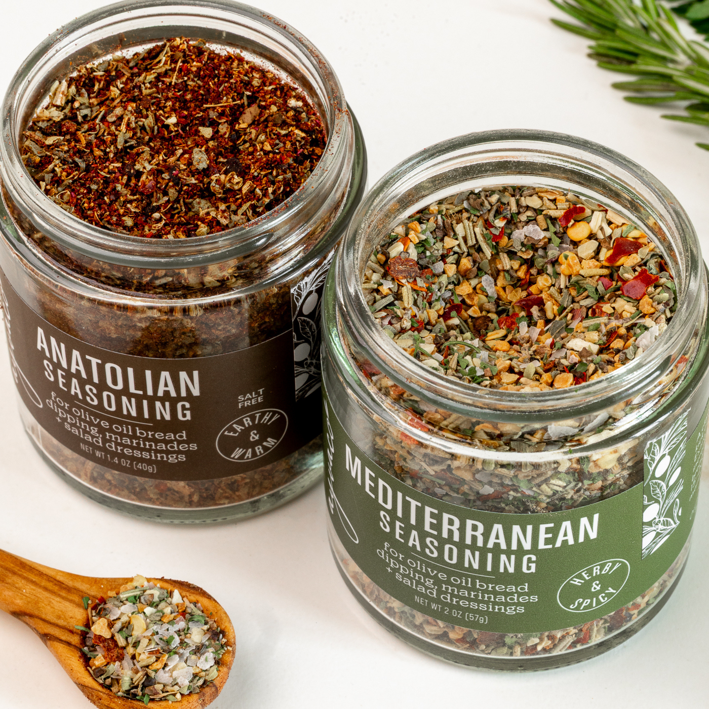 Macro image with detail of Ayvaco Seasoning Duo – Mediterranean and Anatolian spice blends in two full-sized jars with spoon in foreround.